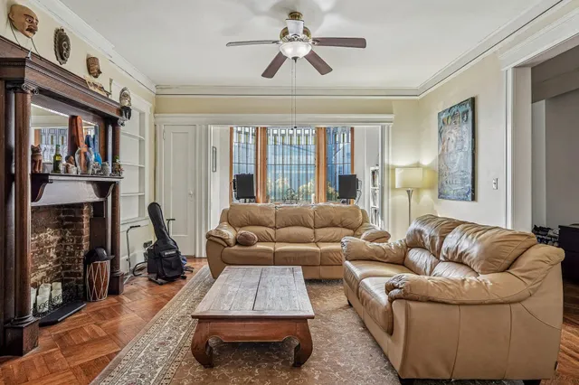 a living room with furniture fireplace and a window