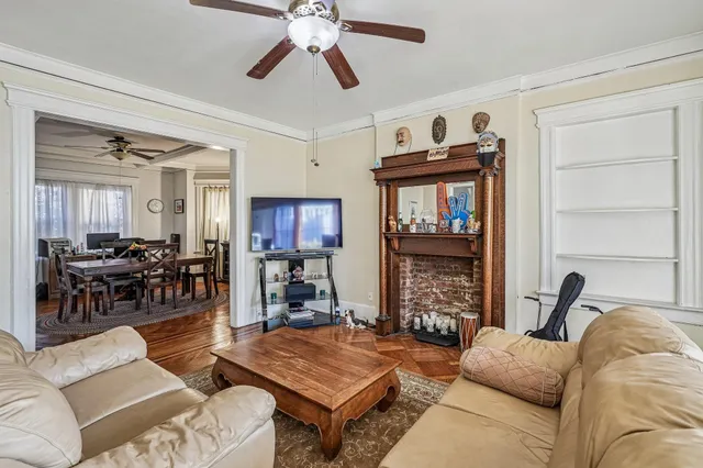 a living room with furniture a fireplace and a flat screen tv