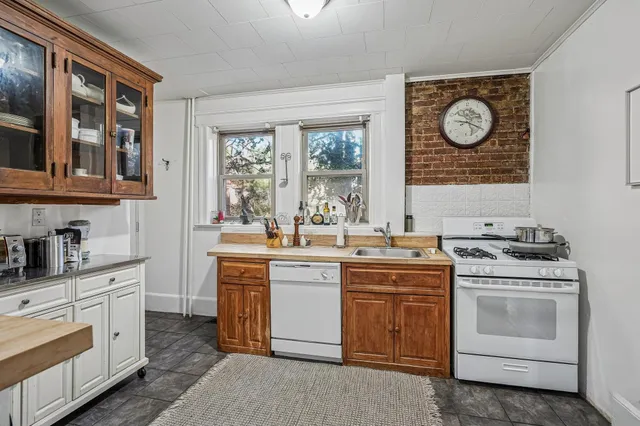 a kitchen with a stove oven and sink