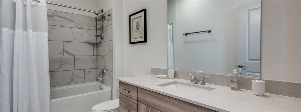 10030 Garland Road, Unit 202 Dallas, TX 75218 - Photo 7 of 16 a bathroom with a granite countertop sink toilet and shower
