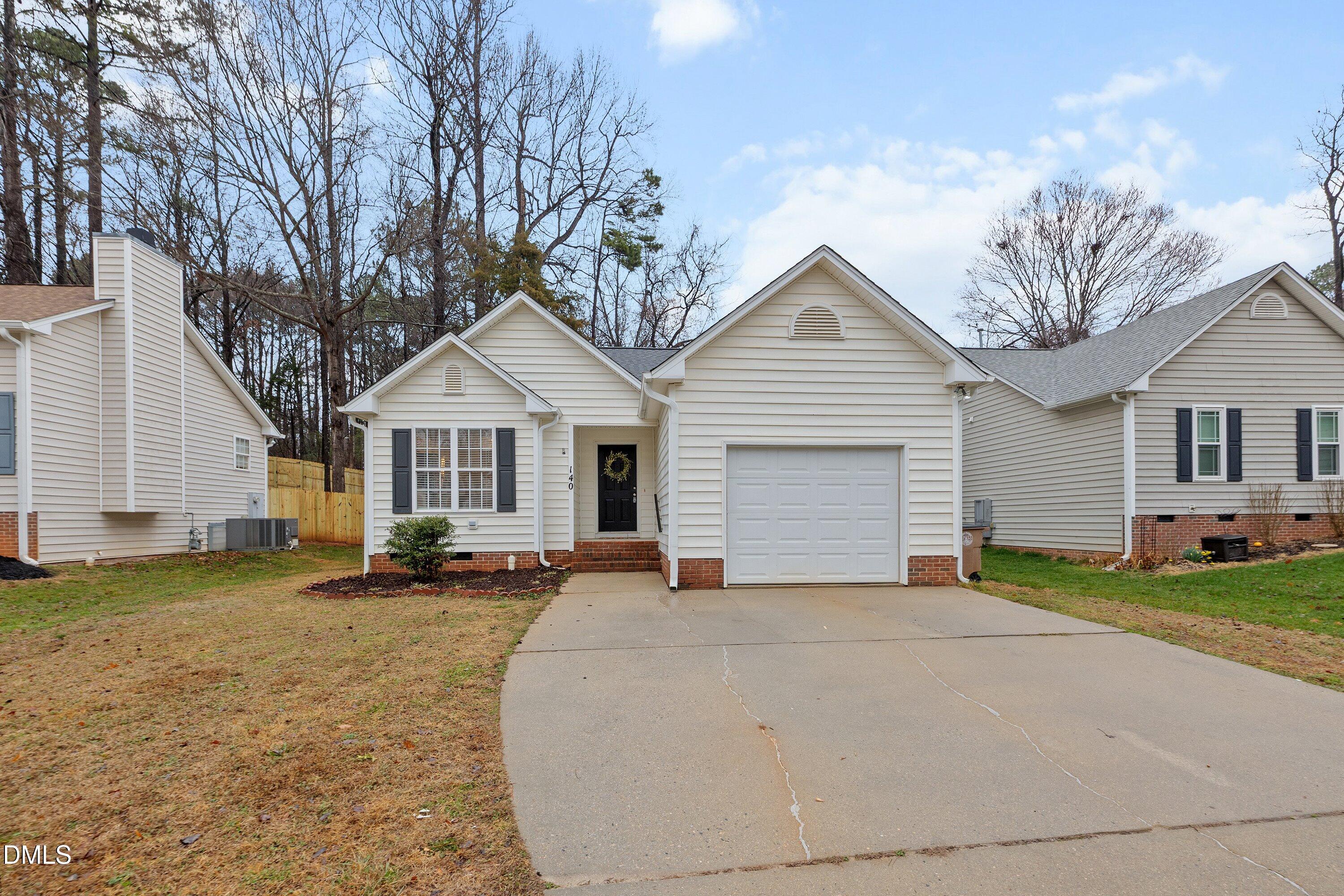 140 Melksham Road Wake Forest, NC 27587 - Photo 33 of 34 a front view of a house with a yard and garage