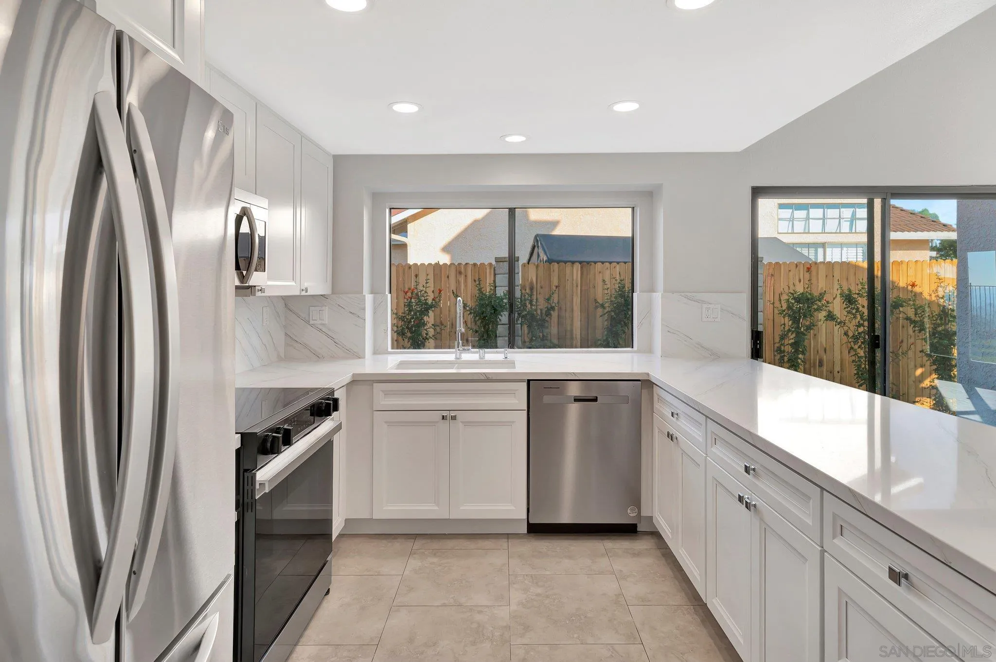 a large white kitchen with a window
