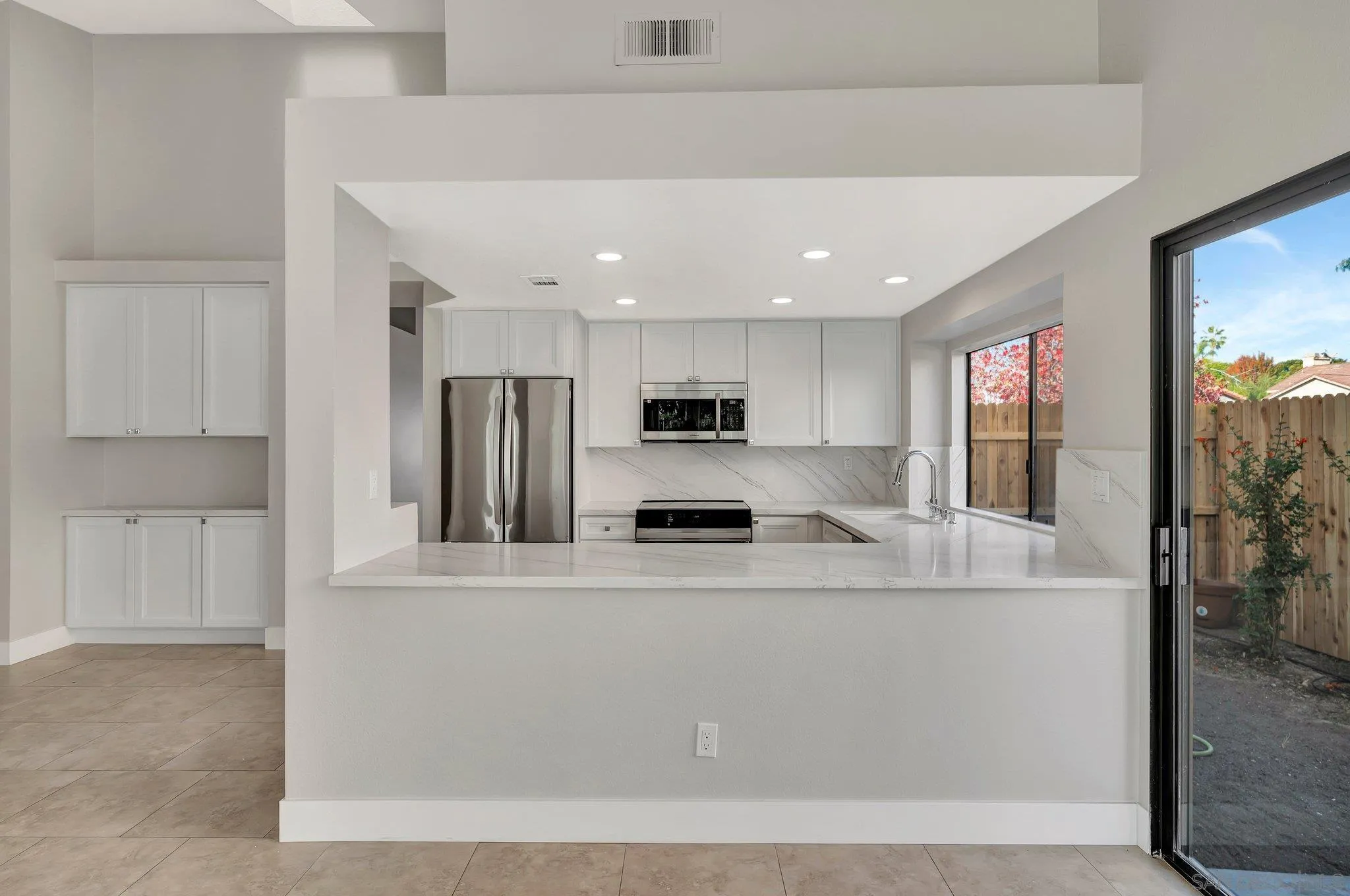 365 Apollo Drive Vista, CA 92084 - Photo 15 of 35 a large white kitchen with stainless steel appliances