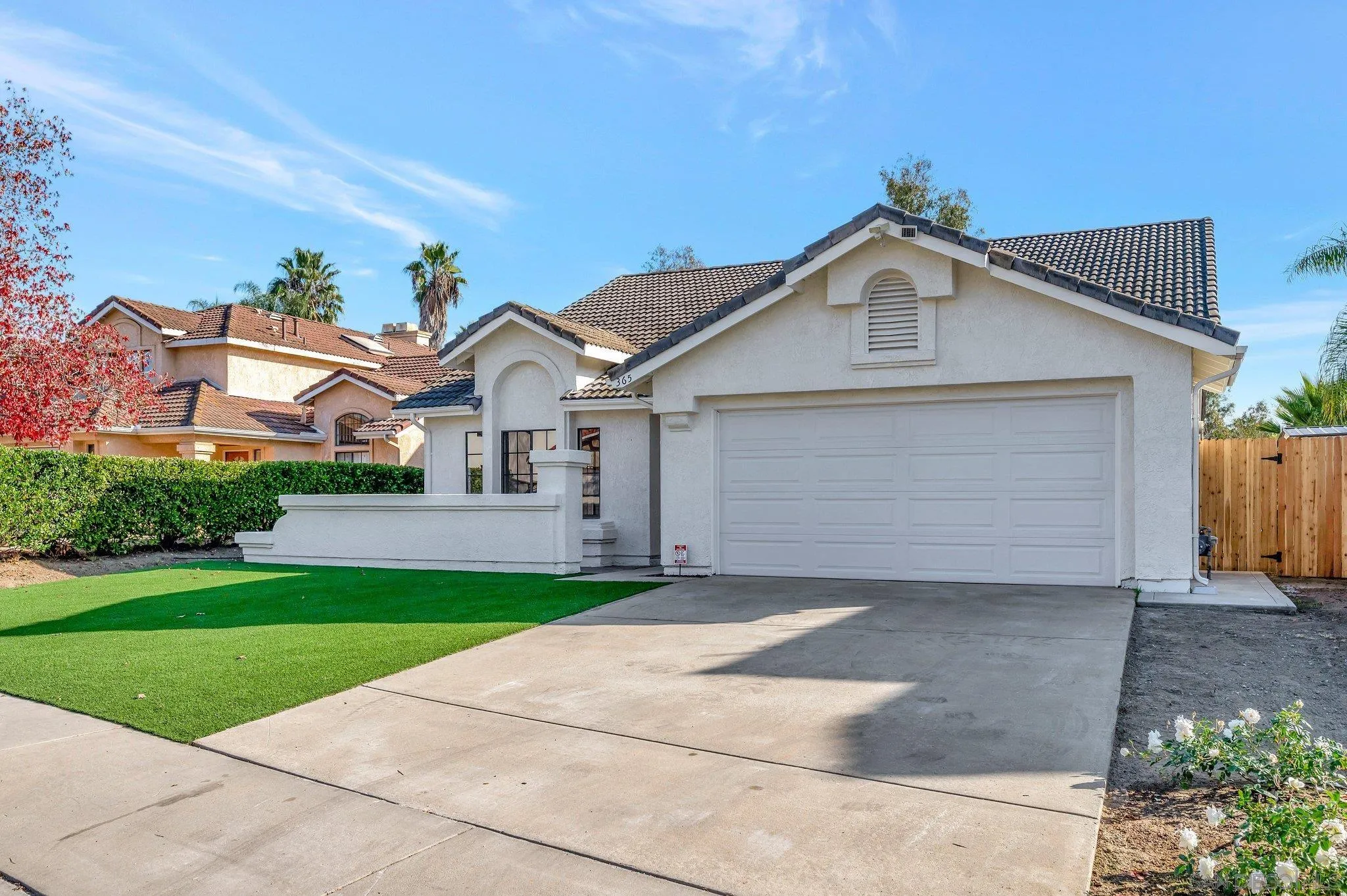 365 Apollo Drive Vista, CA 92084 - Photo 2 of 35 a front view of a house with a yard and garage