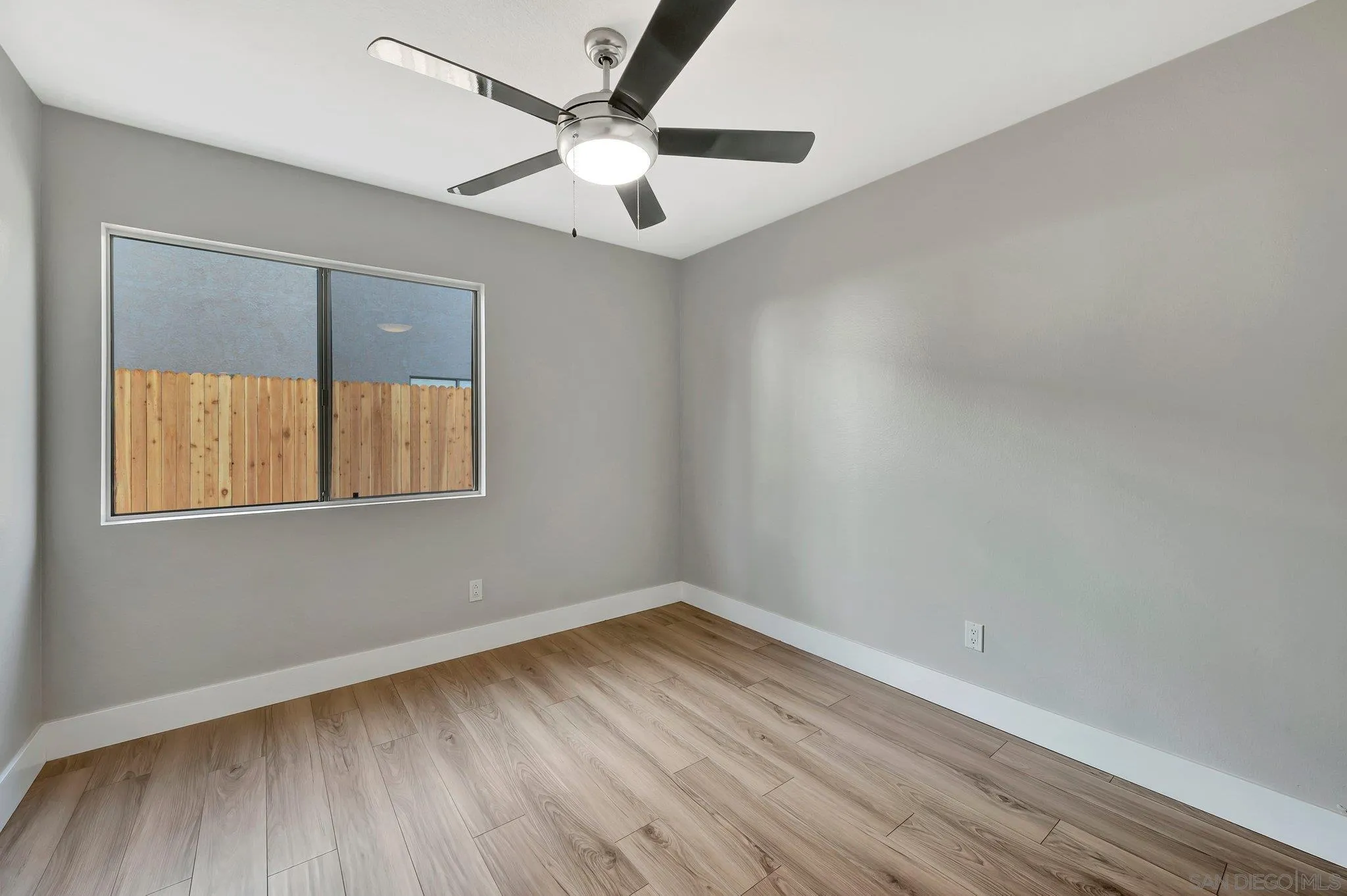 365 Apollo Drive Vista, CA 92084 - Photo 21 of 35 an empty room with a window and a ceiling fan