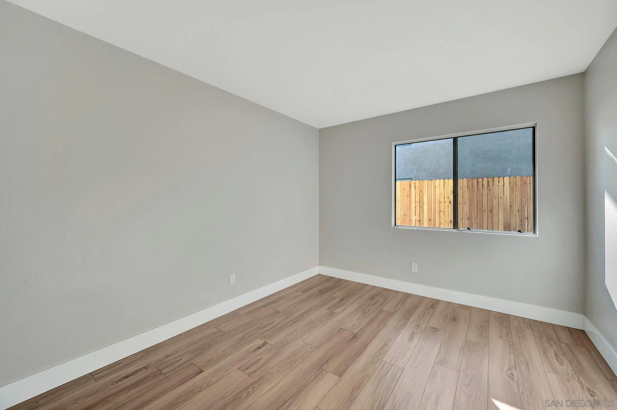 365 Apollo Drive Vista, CA 92084 - Photo 23 of 35 a view of an empty room with wooden floor and a window