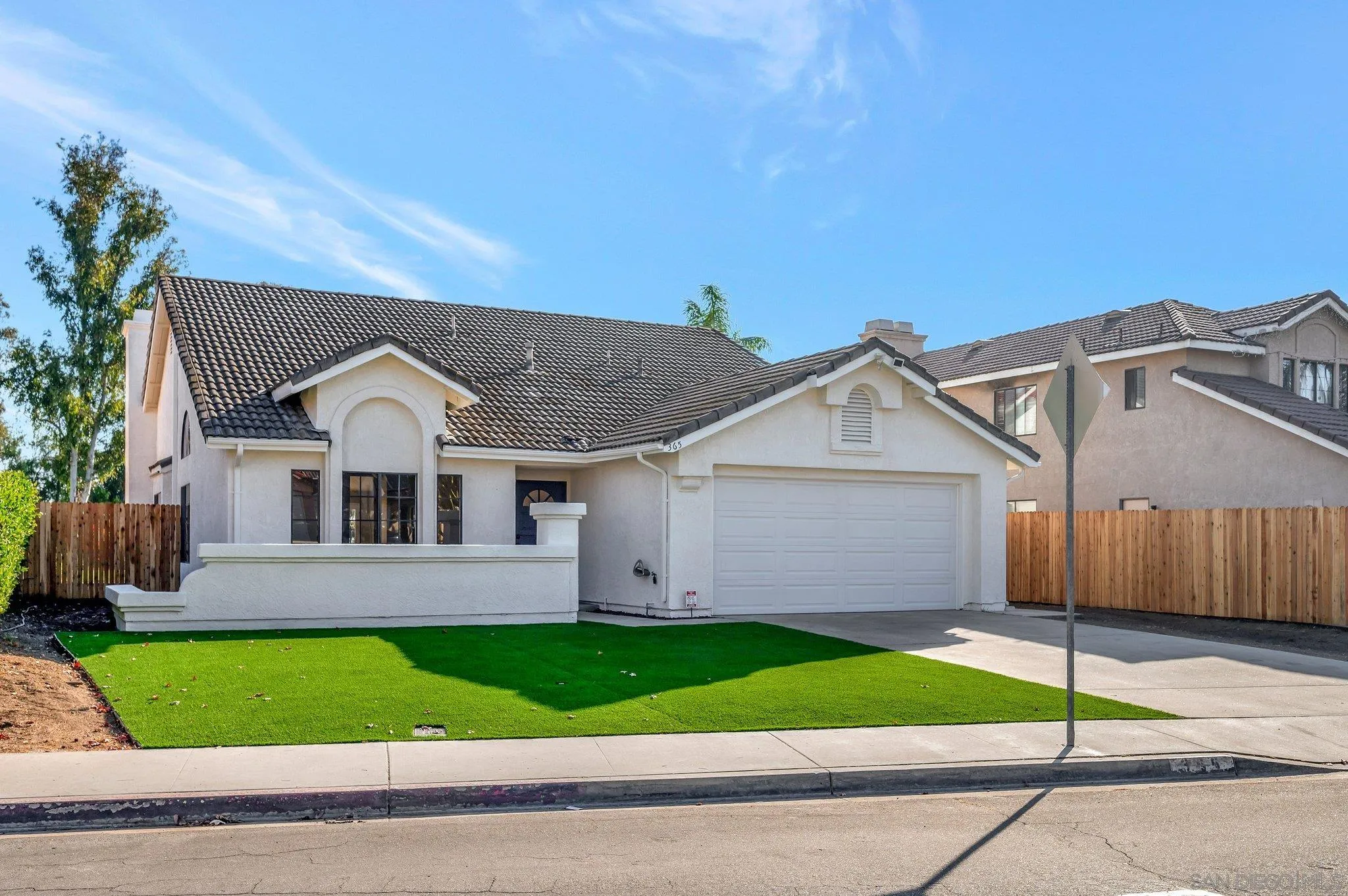 365 Apollo Drive Vista, CA 92084 - Photo 3 of 35 a view of a white house with a yard and large tree