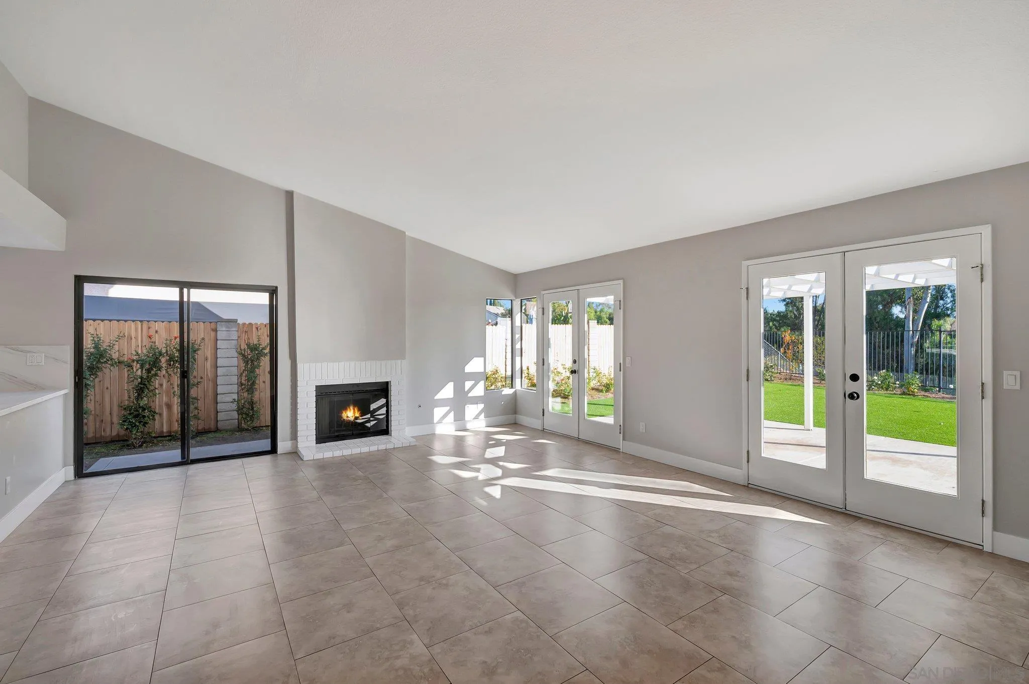 365 Apollo Drive Vista, CA 92084 - Photo 9 of 35 a view of an empty room with a fireplace and a window