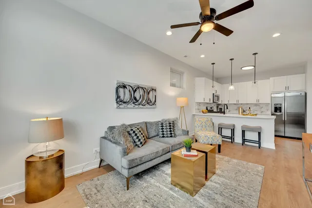 a living room with furniture and kitchen view