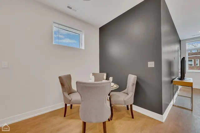 a view of a dining room with furniture and wooden floor