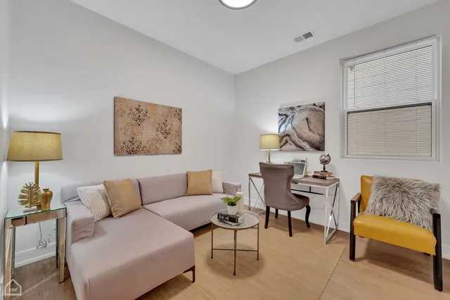 a living room with furniture and a lamp