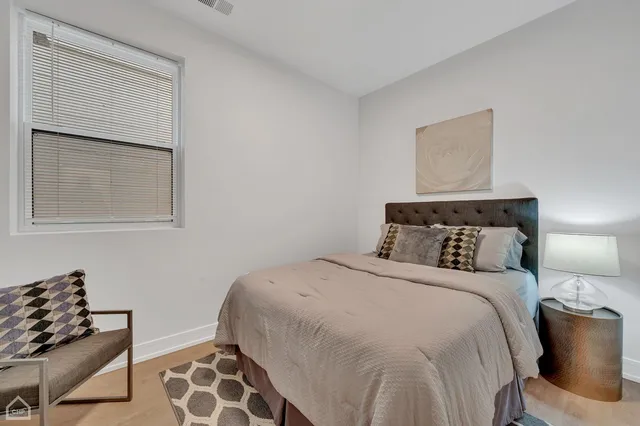 a bedroom with a bed and chair