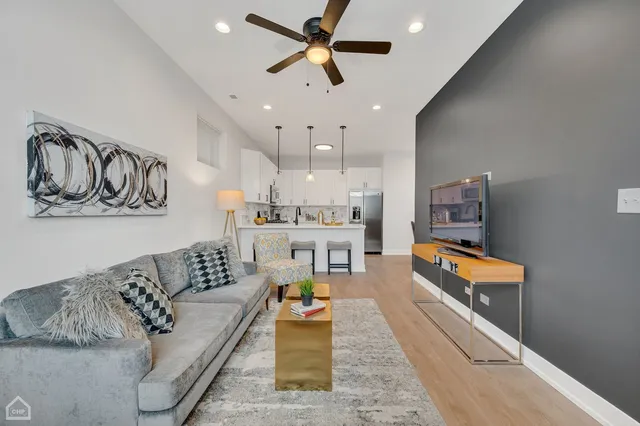 a living room with furniture and kitchen view