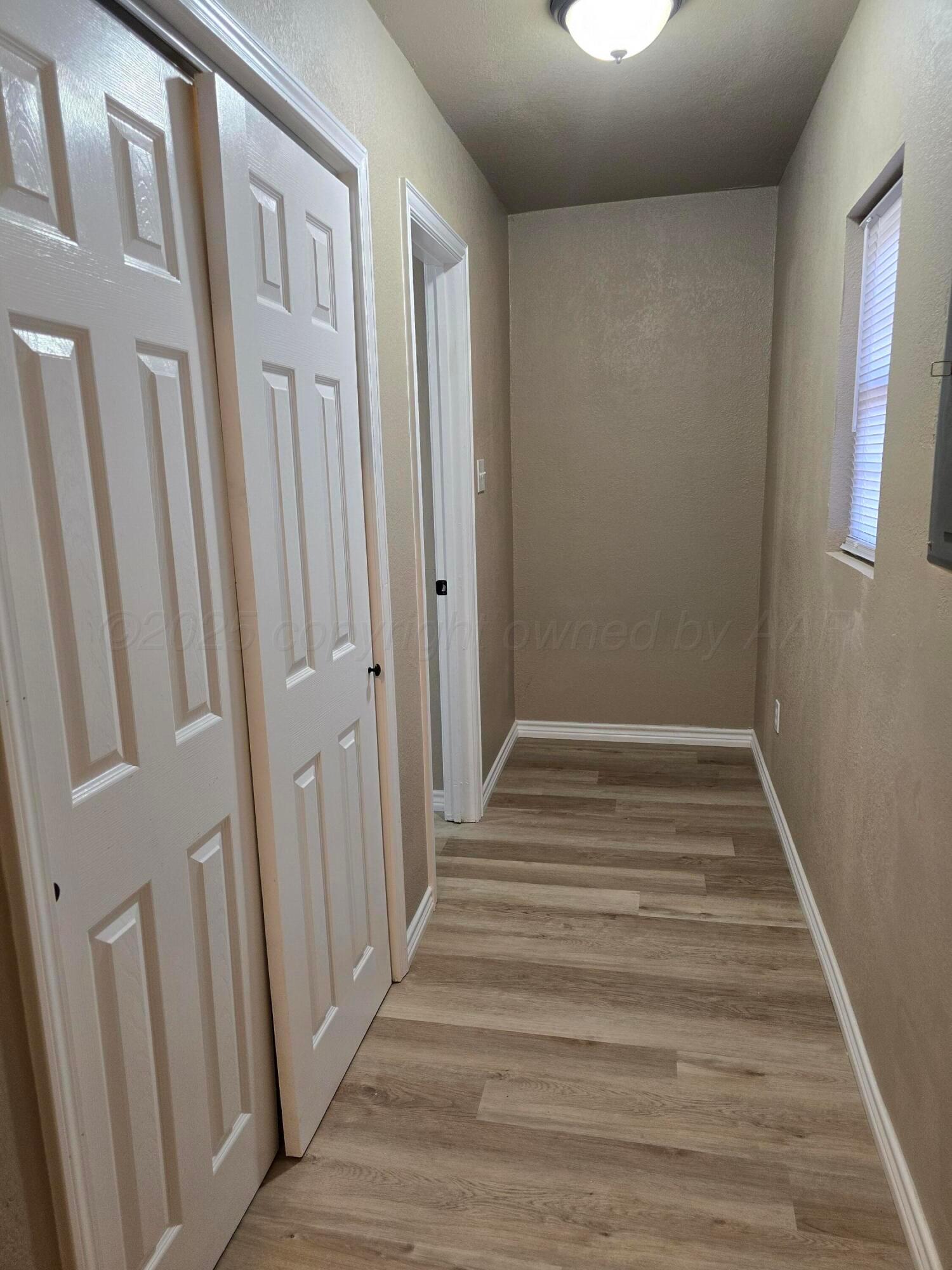 129 Pecan Street Borger, TX 79007 - Photo 14 of 23 a view of a hallway with wooden floor and entryway