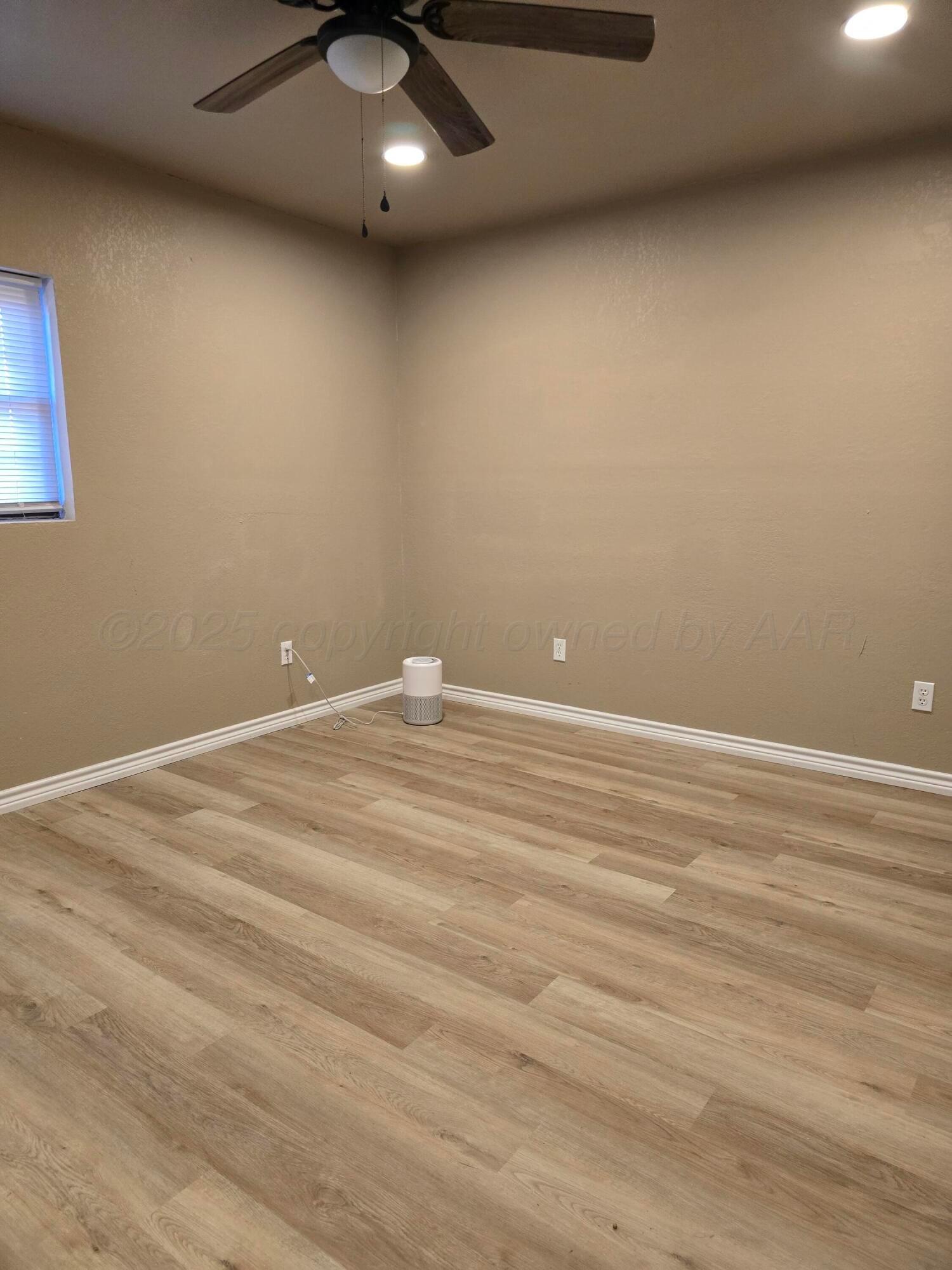 129 Pecan Street Borger, TX 79007 - Photo 16 of 23 wooden floor and cabinet in an empty room
