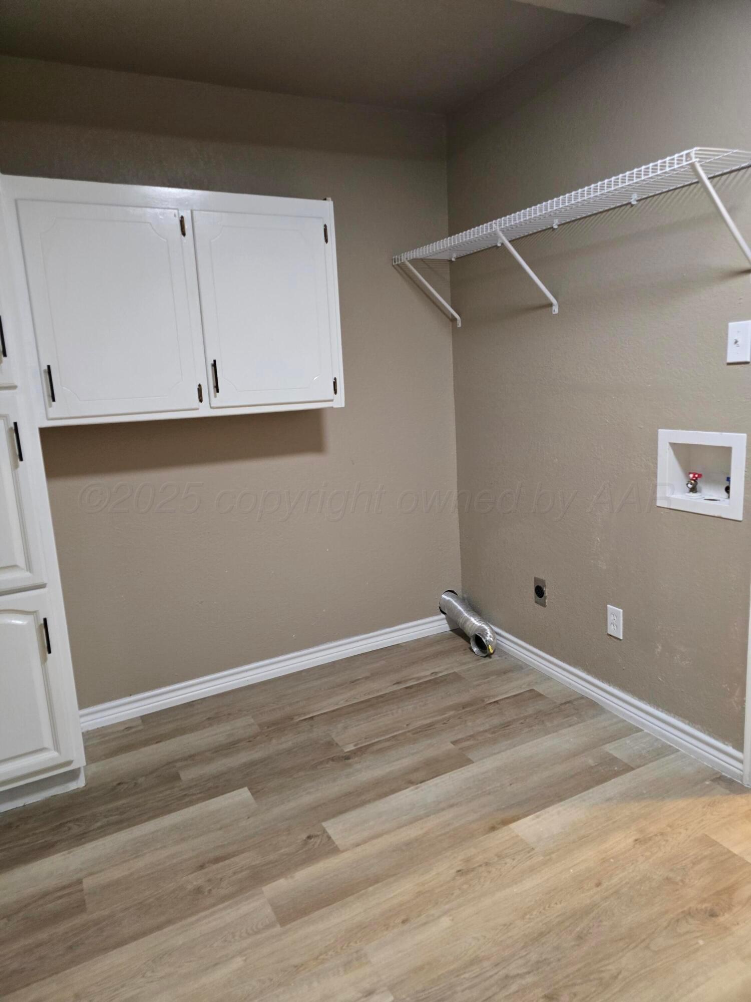 129 Pecan Street Borger, TX 79007 - Photo 9 of 23 a view of a room with wooden floor and cabinet
