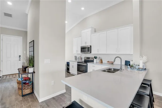 a kitchen with a white stove top oven and cabinets