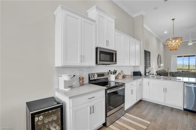 a kitchen with a sink stove and microwave
