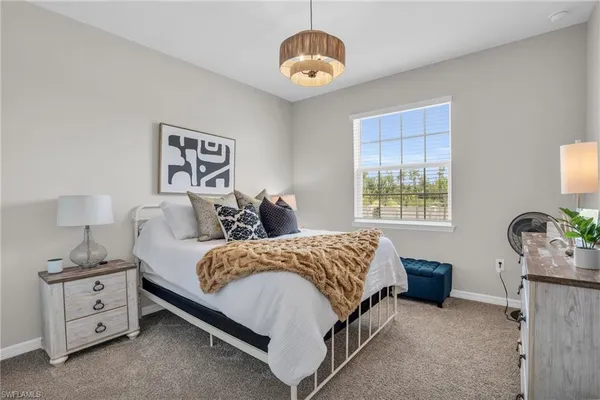 a spacious bedroom with a bed and a window