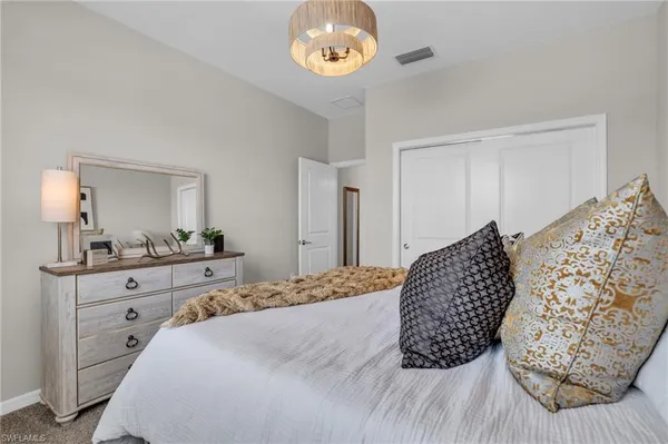 a bedroom with a bed and a dresser