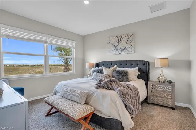 a bedroom with a bed and window