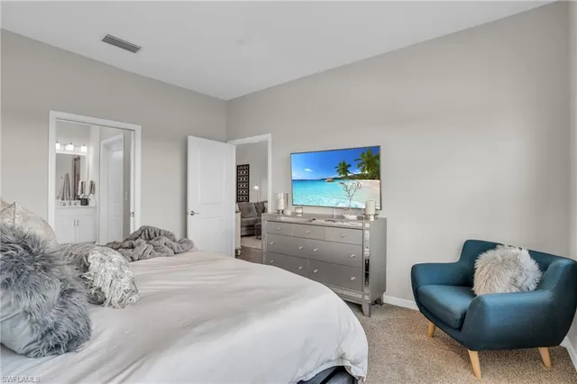 a bedroom with a bed and a couch