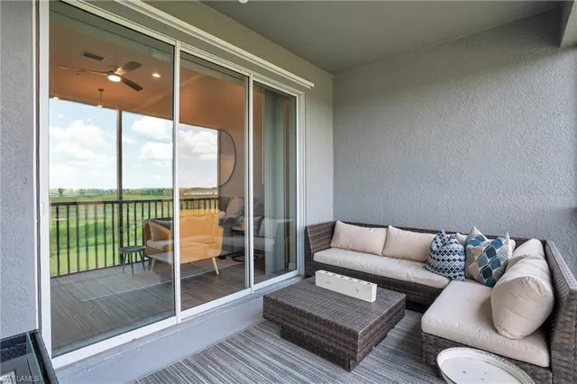 a living room with furniture and a floor to ceiling window
