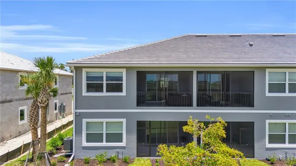 a front view of a house with a large window and a potted plant