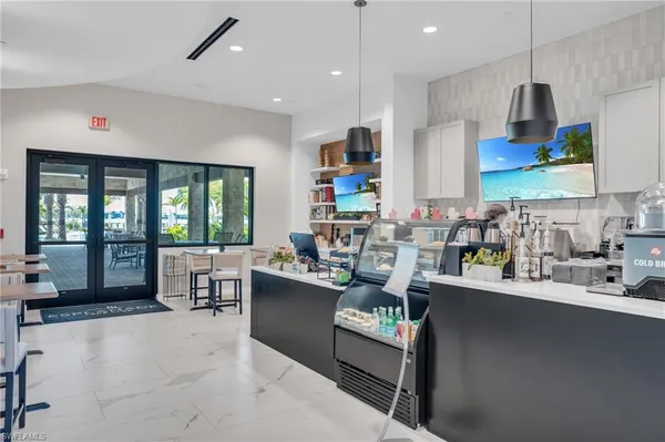 a living room with stainless steel appliances kitchen island granite countertop furniture and a large window