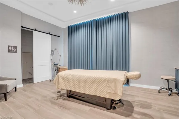 a bedroom with a bed and a chair in it