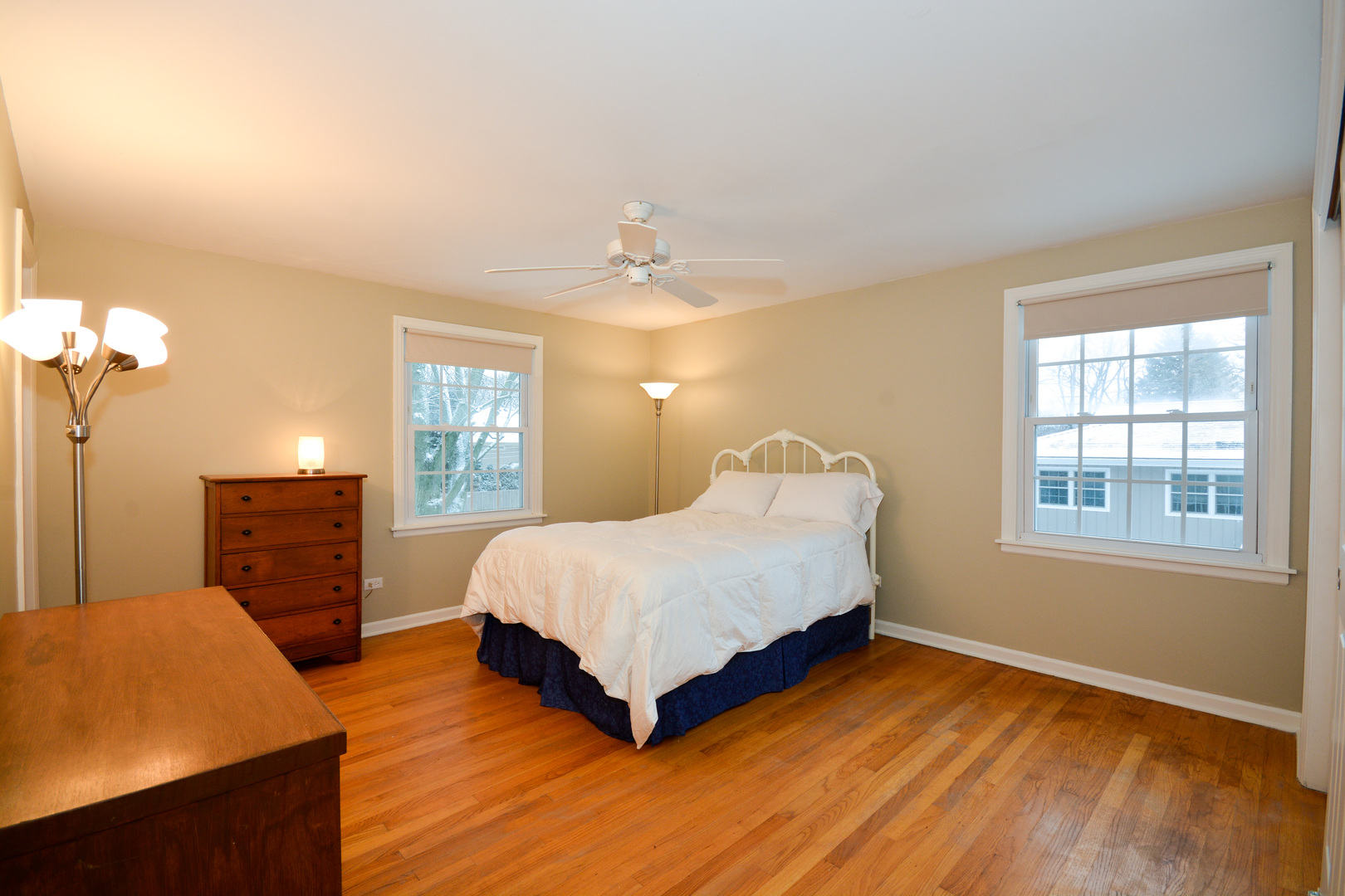 26W564 Jewell Road Winfield, IL 60190 - Photo 20 of 40 a spacious bedroom with a bed and dresser with wooden floor