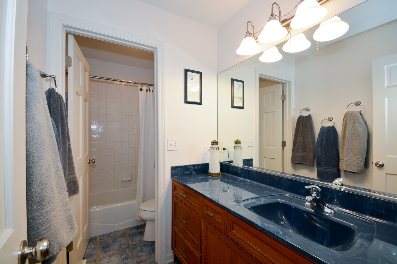 26W564 Jewell Road Winfield, IL 60190 - Photo 27 of 40 a bathroom with a granite countertop sink a toilet and a mirror