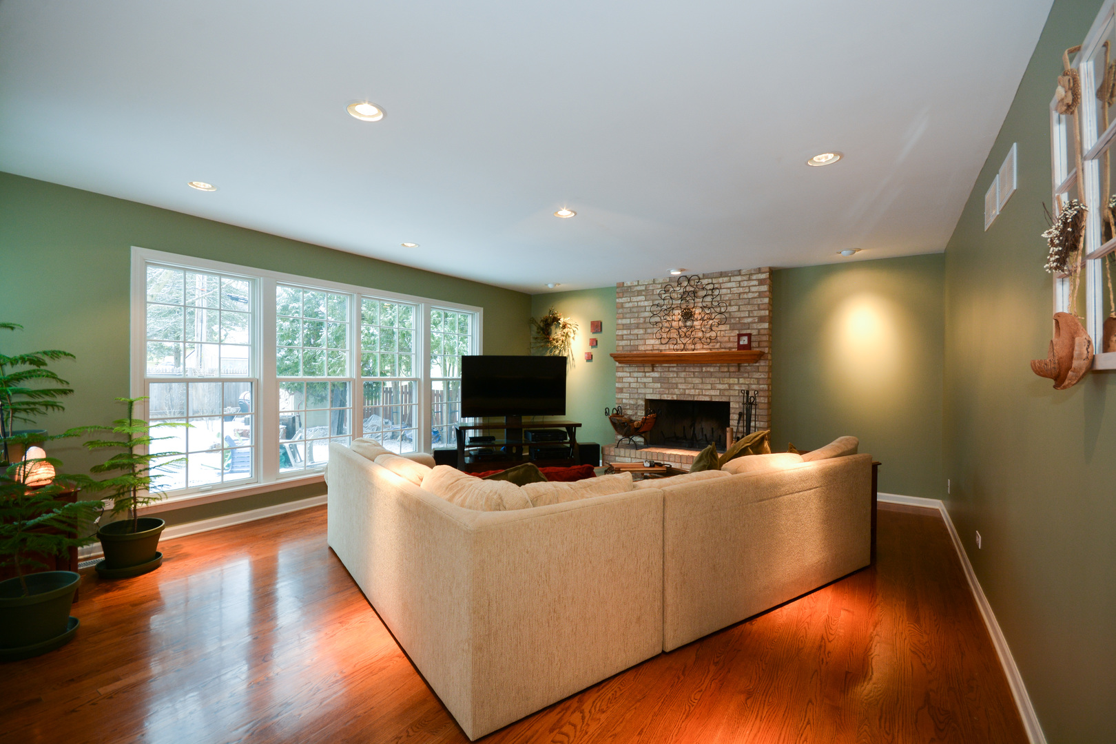 26W564 Jewell Road Winfield, IL 60190 - Photo 10 of 40 a living room with furniture a fireplace and a flat screen tv