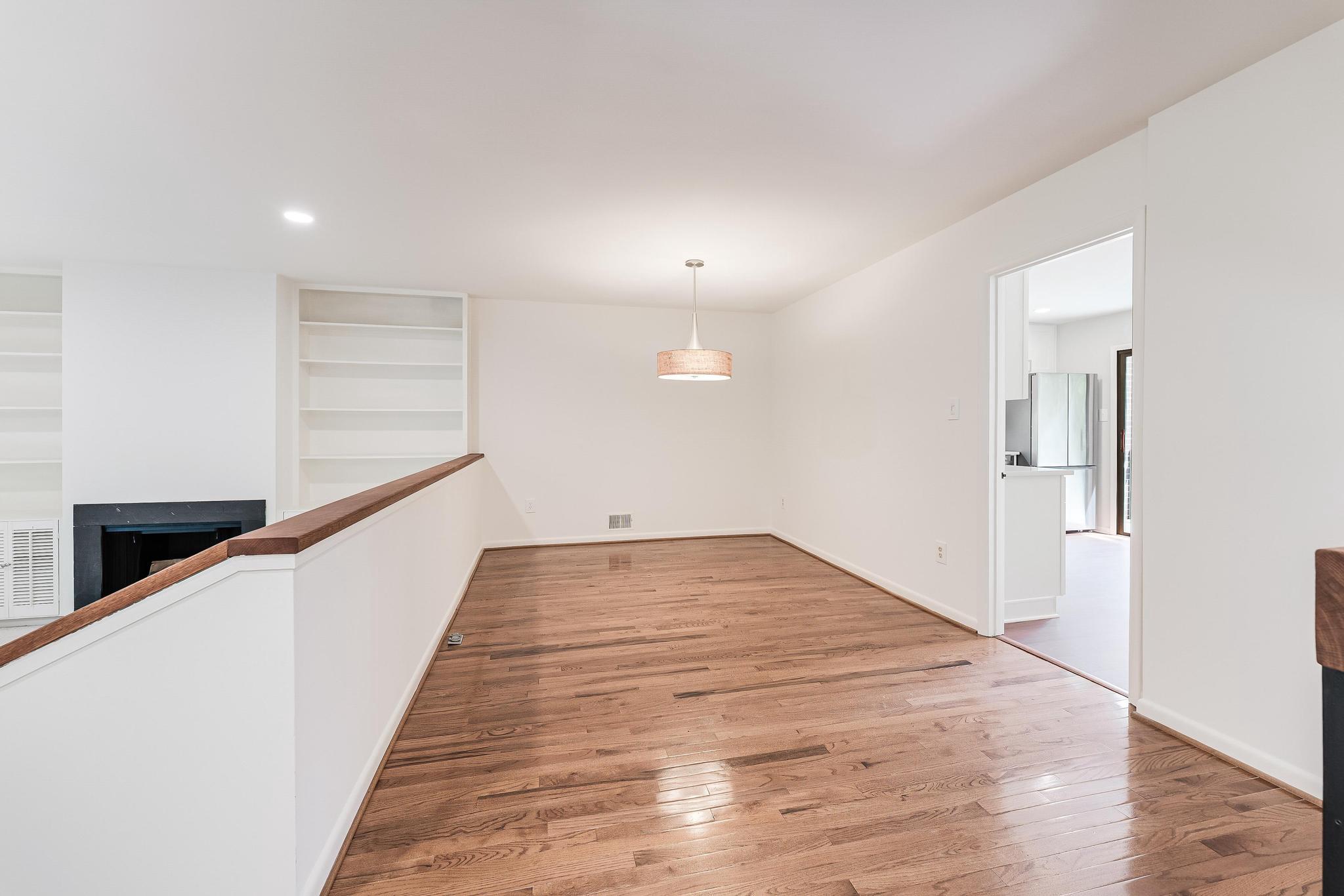 12023 Insha Court Reston, VA 20191 - Photo 26 of 52 a view of a hallway with wooden floor and staircase