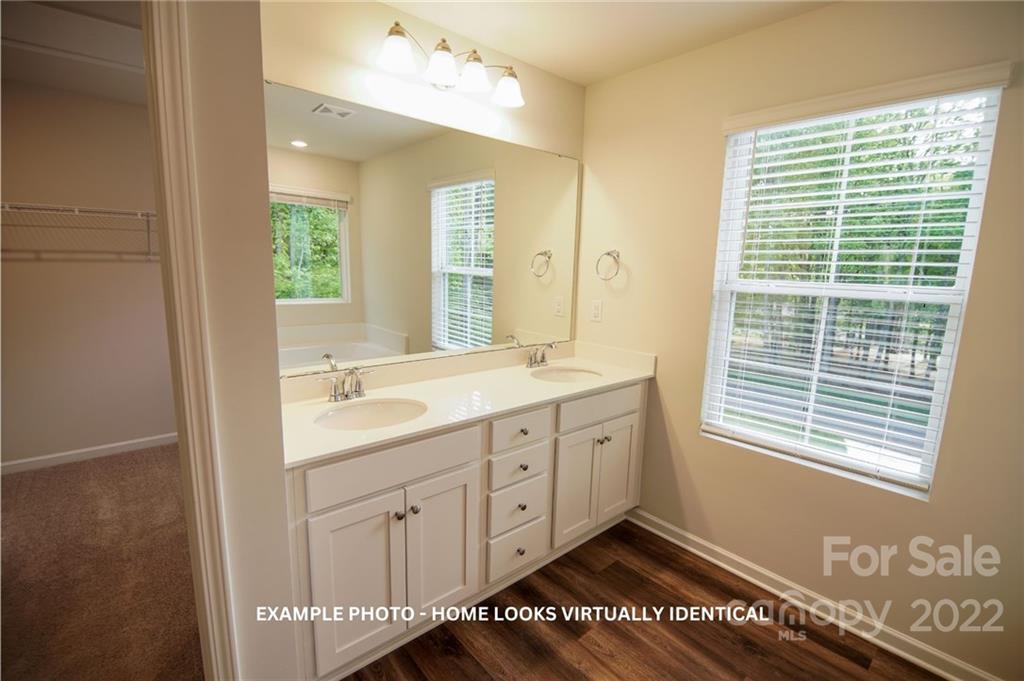 4960 Long Ferry Road Salisbury, NC 28146 - Photo 7 of 14 a spacious bathroom with a double vanity sink a large mirror and a bathtub