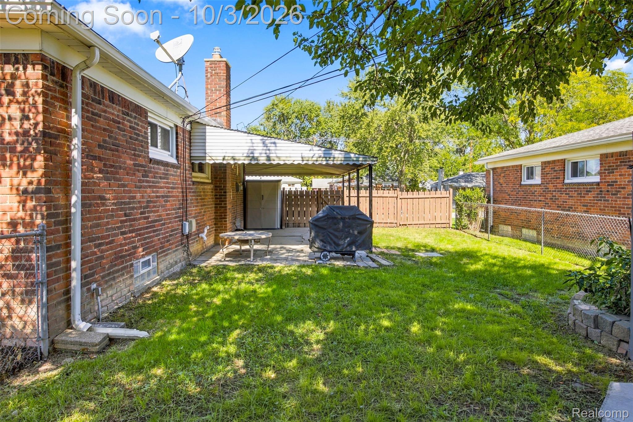 556 Henry Ruff Road Garden City, MI 48135 - Photo 29 of 49 Brick exterior featuring a covered patio, a fenced yard, and a stone retaining wall