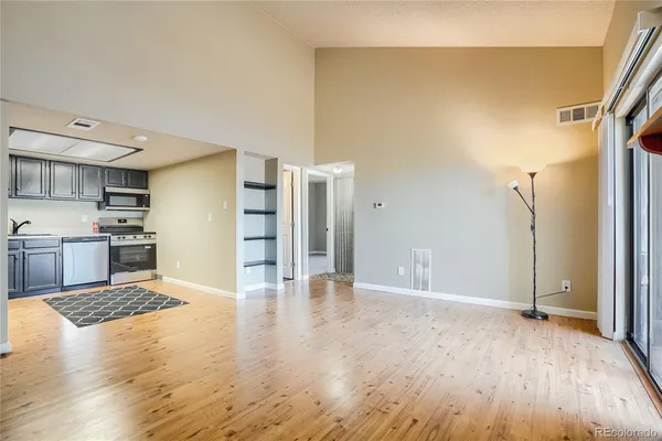 a view of a kitchen with wooden floor and a kitchen
