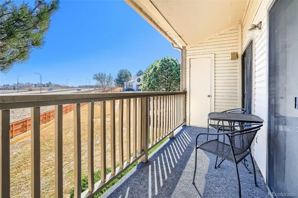 a view of a chairs and table in the balcony