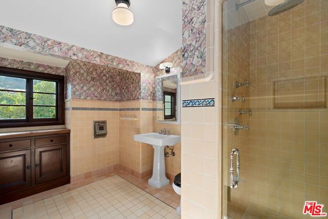 a bathroom with a sink mirror vanity and toilet