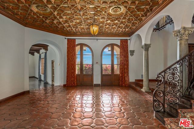 a view of empty room with wooden floor fireplace and a window