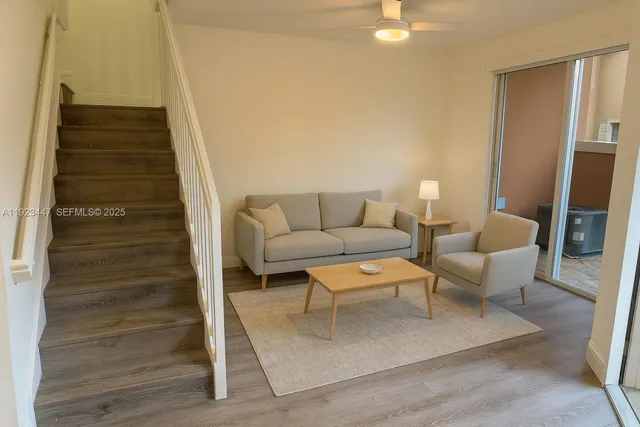 a living room with furniture and a rug