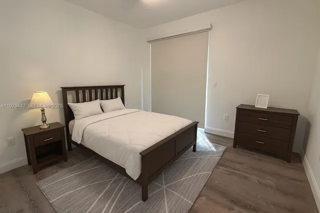 a bedroom with a bed and a lamp