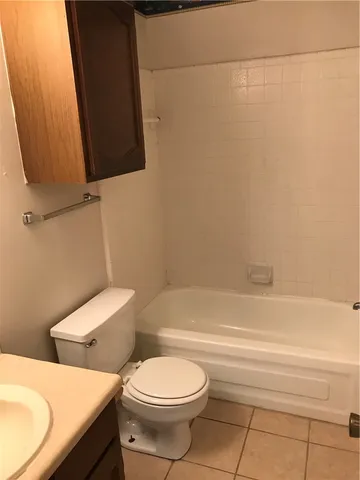 a bathroom with a toilet and a bathtub