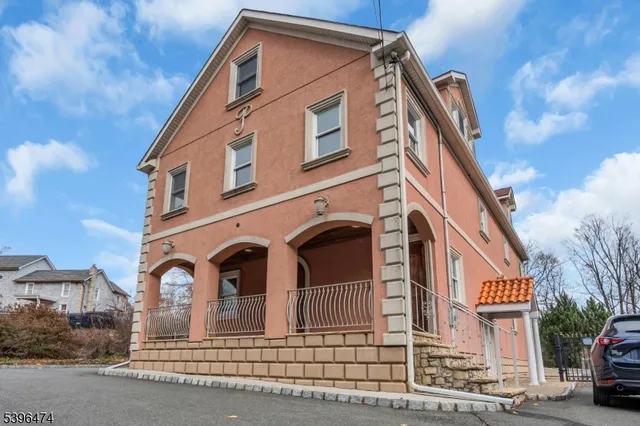 a front view of a house with a street