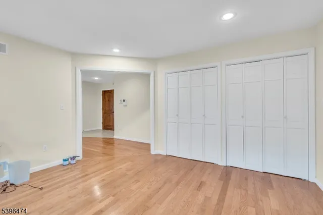 a view of an empty room and wooden floor