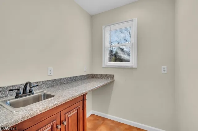a kitchen with granite countertop a sink and a window