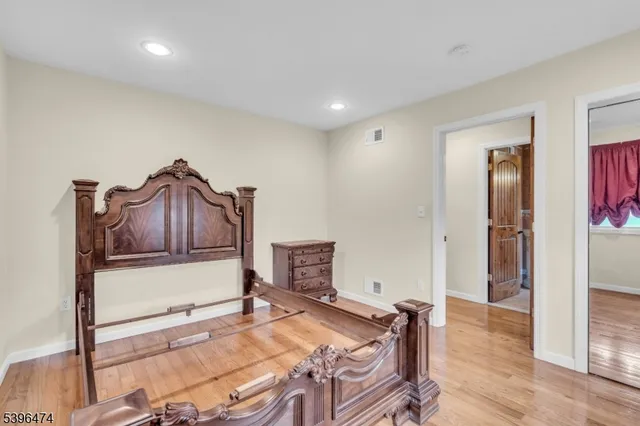 a room with a bed and a dresser