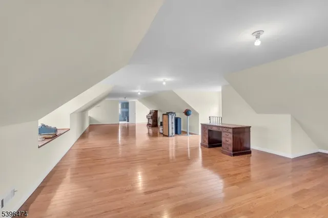 a hallway with wooden floor and furniture