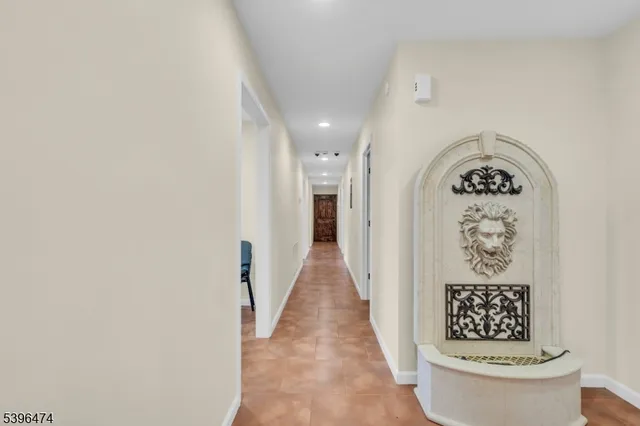 a view of a hallway with paintings on the wall
