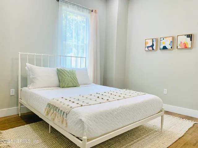 a bedroom with a bed and a window